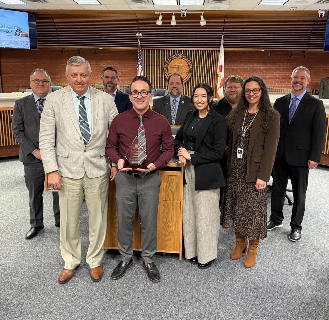 Hernando County leadership and Swiftbuild team receiving the APA/NACP Award of Excellence in Best Practices in the county commission chamber