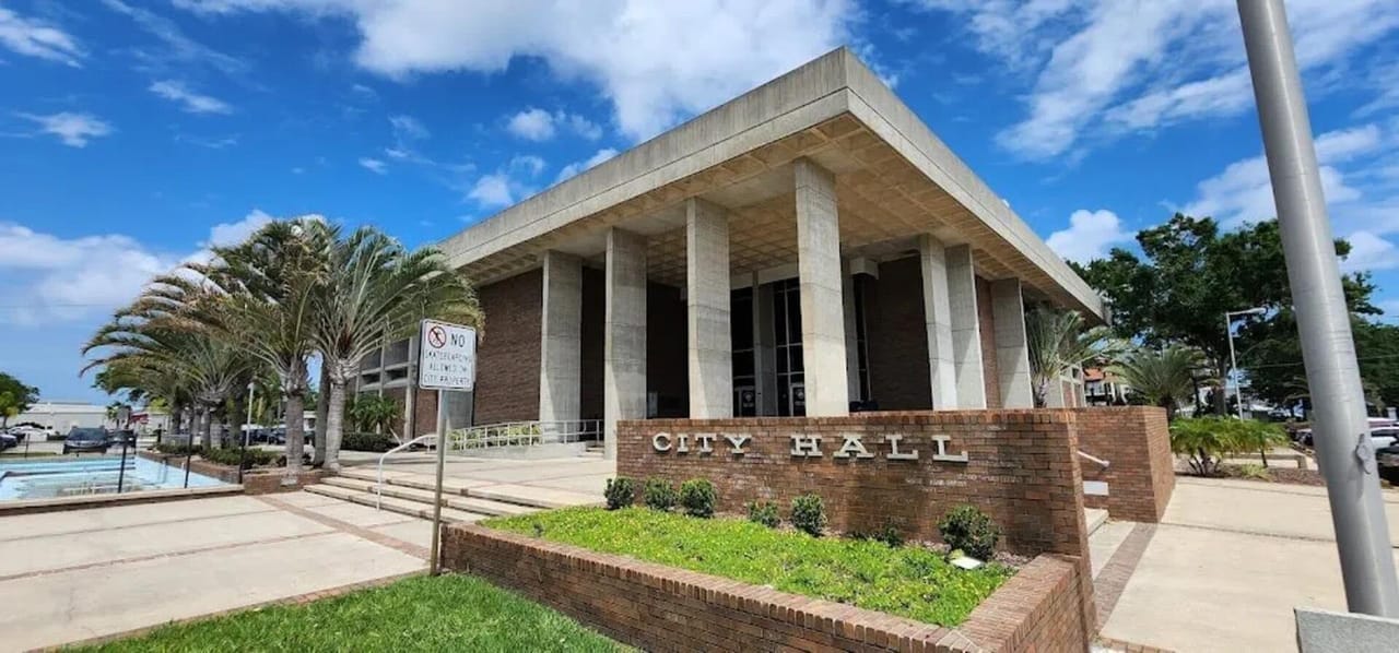 Titusville City Hall, a modernist concrete and brick civic building with City Hall signage and palm trees